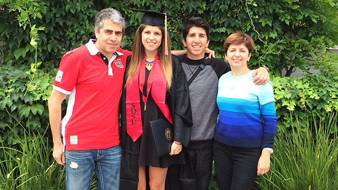 SDSU alumna Nirit Wigdor in her cap and gown photographed with her family.