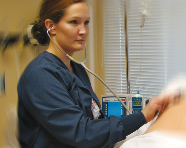 Nursing student Natalie Claypool works with a Human Patient Simulator.