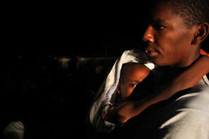 A father holds his son after Tuesday's 7.0 earthquake in Haiti