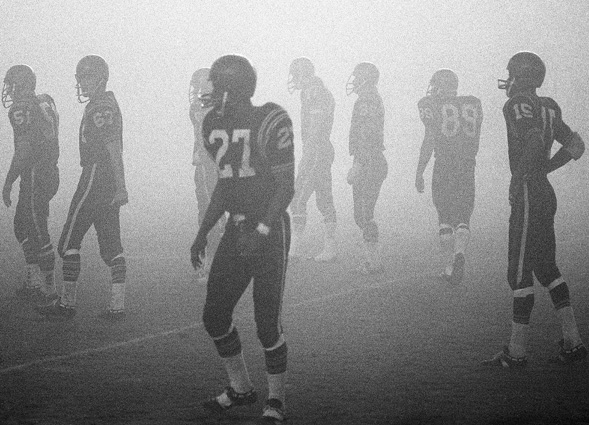 SDSU football players battle foggy conditions during a 1968 game against San Jose State.