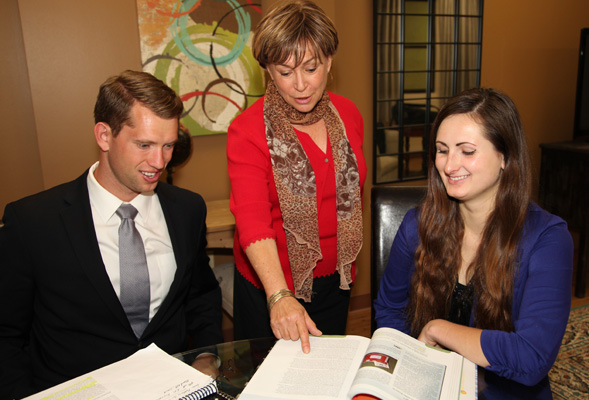 Linda Guzzo, center, checks with Adam Seperack and Lucy Velasquez on the progress of their internships.