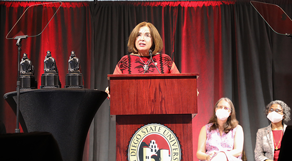 SDSU President Adela de la Torre spoke at the 2021-22 All-University Convocation. At left, the Alumni Distinguished Faculty Awards statuettes. (Photo: Scott Hargrove)