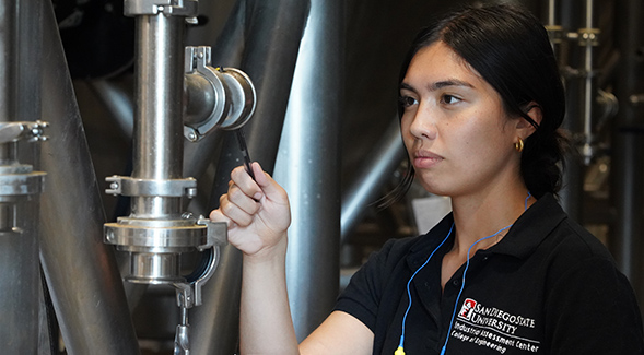 Undergraduate Kaylin Sabado performs an energy efficiency assessment with the SDSU Industrial Assessment Center.