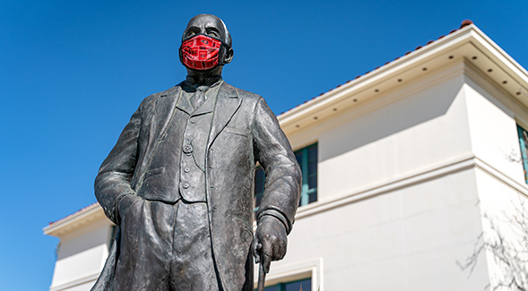 The statue of President Samuel T. Black with a facial covering