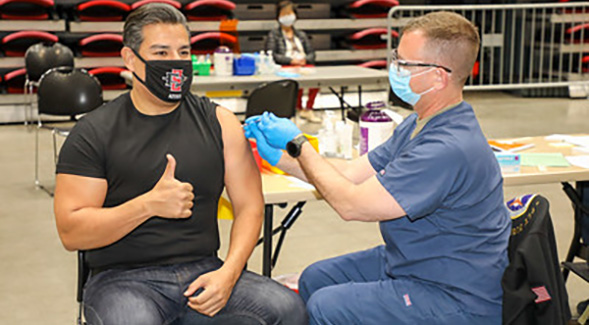 A COVID-19 vaccination at Viejas Arena in April.