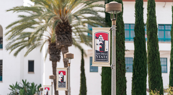 The spring 2022 semester at SDSU will begin with virtual instruction. Above, an image of campus banners. (Photo: Gary Payne)