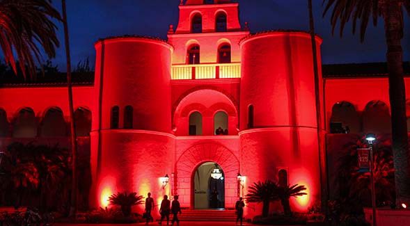 Hepner Hall was illuminated in red for the Homecoming Week Light the Down Red celebration of Aztec pride. (Photo: Sandy Huffaker)