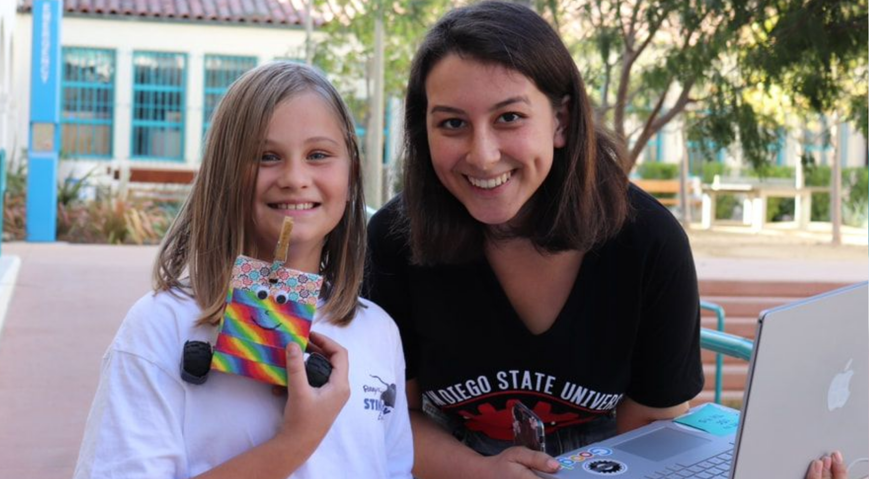 An SDSU SWE member poses with an elementary-aged student participating in one of their outreach activities on campus. (SDSU)
