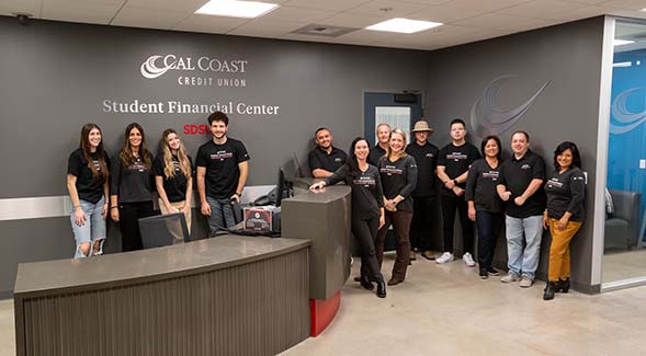 The staff of the Cal Coast Student Financial Center posed in the remodeled lobby. See footnote for identifications. (Photo: Erik Good)