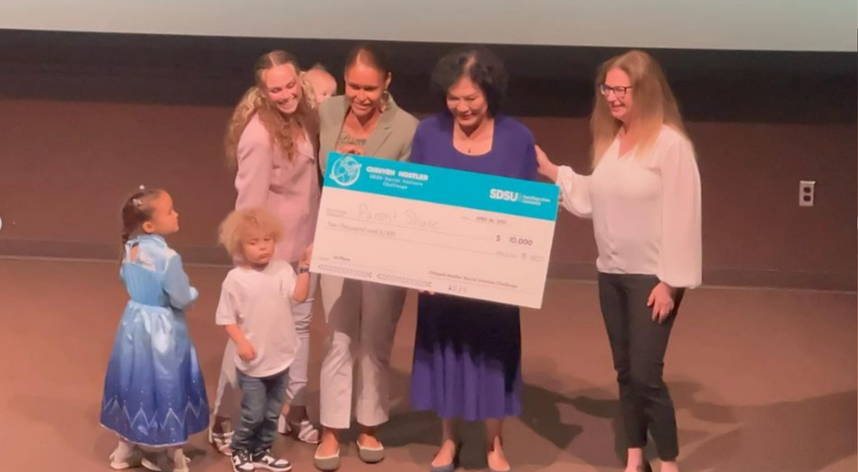 Chinyeh Hostler (second from right) and Cathy Pucher (right) of the ZIP Launchpad present the winning check to the founders of Parent Share. (SDSU)