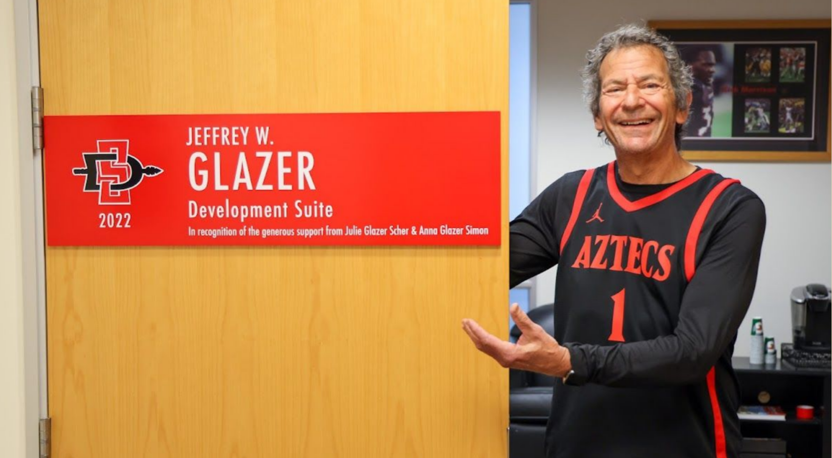 Jeff Glazer posed at the door to the Development Suite at Fowler Athletics Center named in his honor.