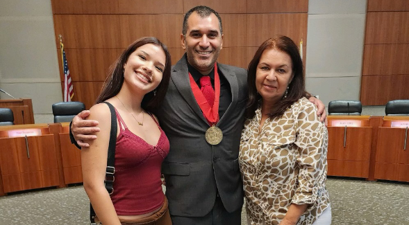 Jahaziel Sanchez, joined by his niece (left) and mother, accepts the CSU Trustees' Award during the award's presentation in Long Beach last Tuesday. (Courtesy of Jahaziel Sanchez)