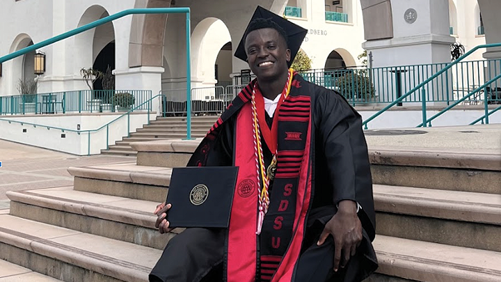 SDSU graduate Melvin Ridley III sits on the steps of the Conrad Prebys Aztec Student Union with his bachelor’s degree in political science. 