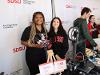 Volunteers pose with a robotic hand, educating attendees on a range of engineering principles and capabilities at SDSU.
