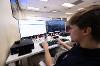 Finance student Anthony Toma views financial information displayed on a Bloomberg Terminal. (Andre Young/SDSU)