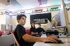 Samuel Jenkins (foreground) works on one of the lab’s Bloomberg Terminals. (Andre Young/SDSU)