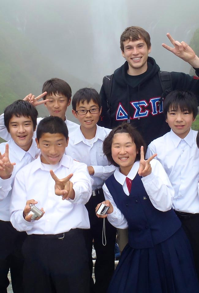 SDSU student with a group of children in Japan
