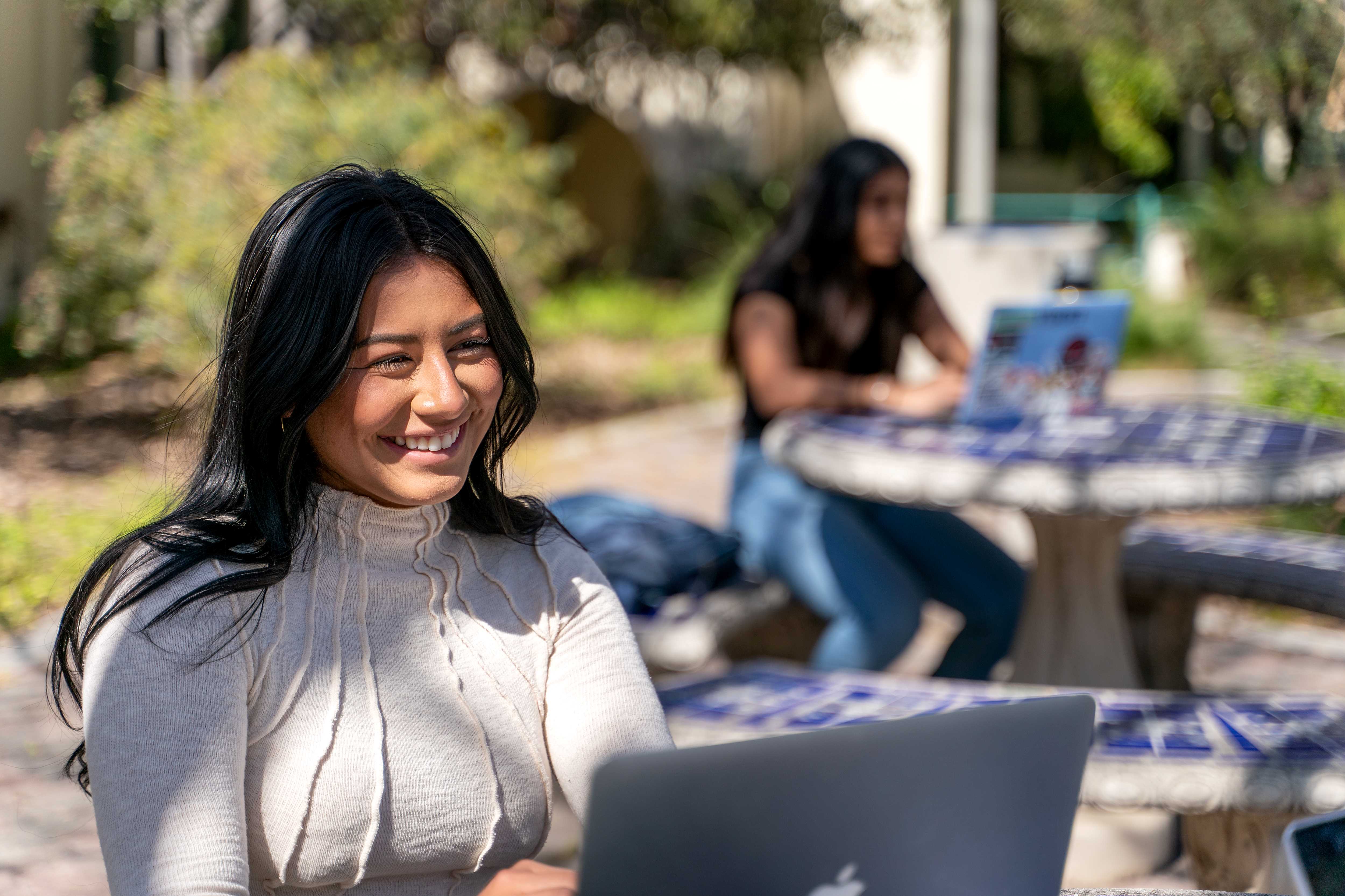 Woman smiling while on laptop.