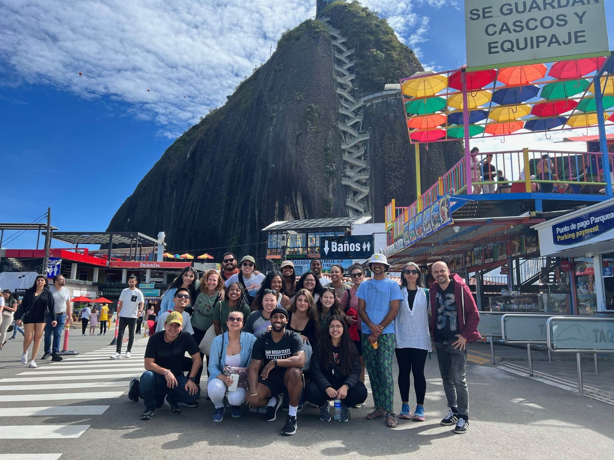 The MFT cohort poses in front of El Penon de Guatape