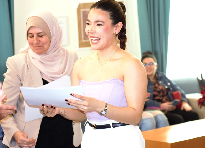 SDSU student smiles as she receives her University Seal of Biliteracy and Cultural Competence award