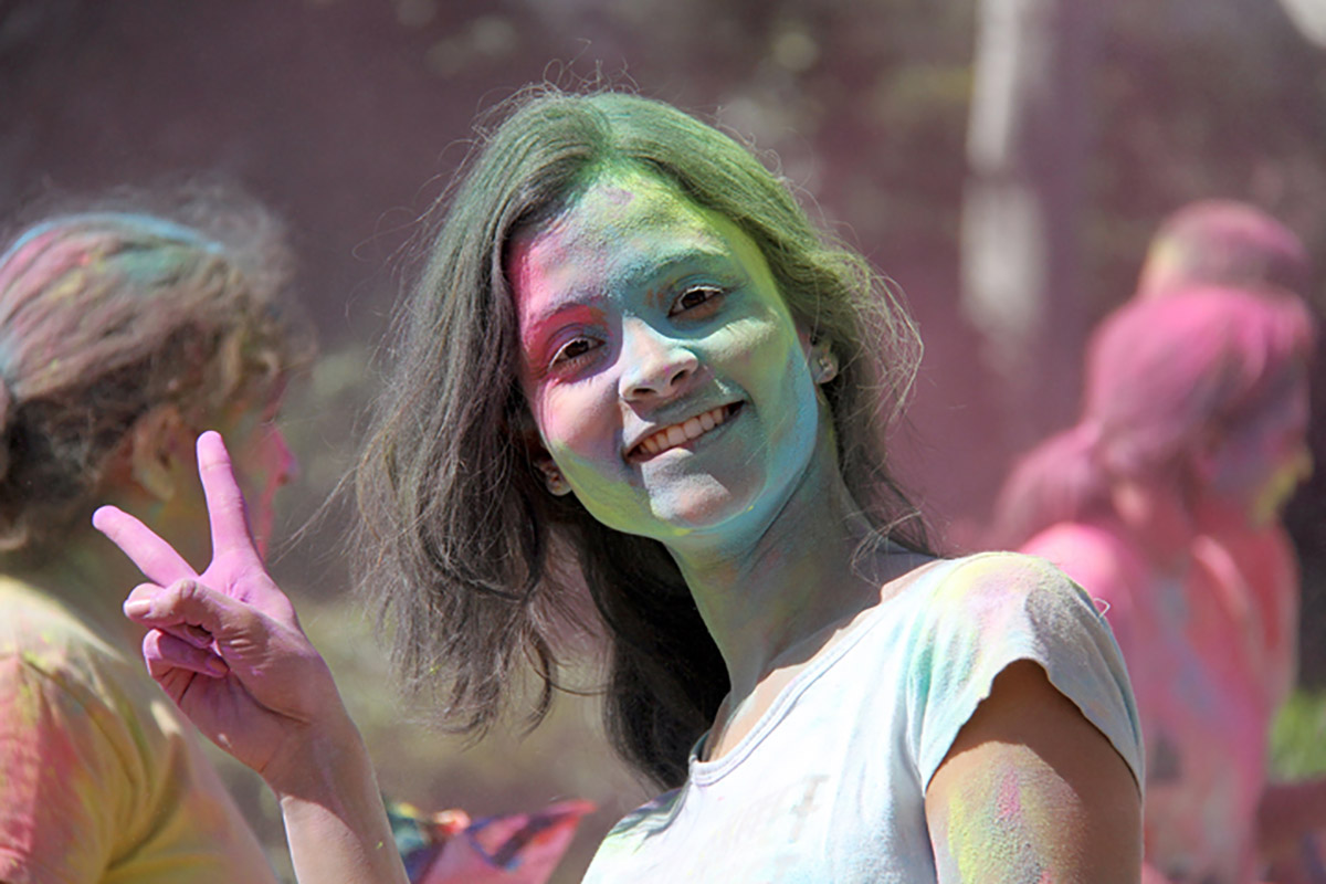 student covered in colored chalk