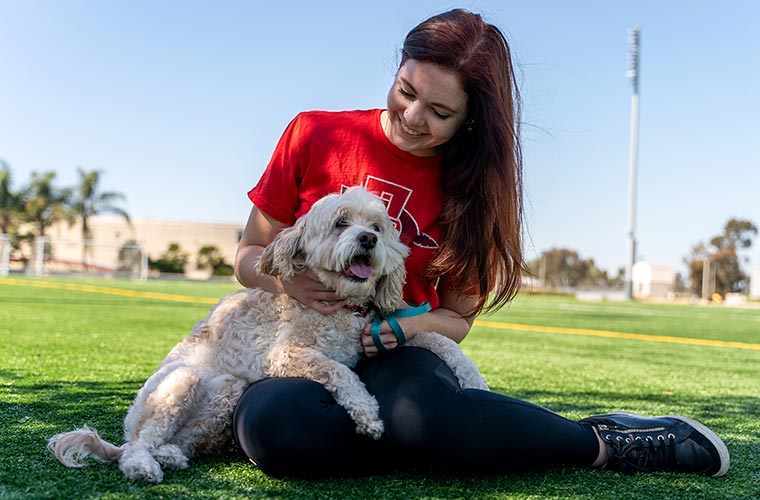 A student interacts with a therapy dog