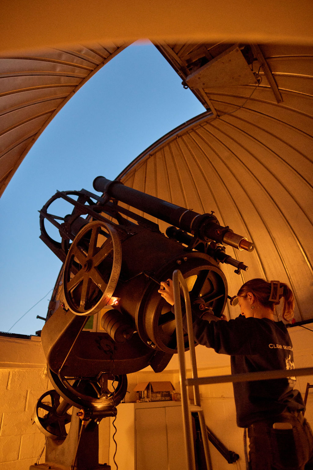 Image of a person using a telescope.
