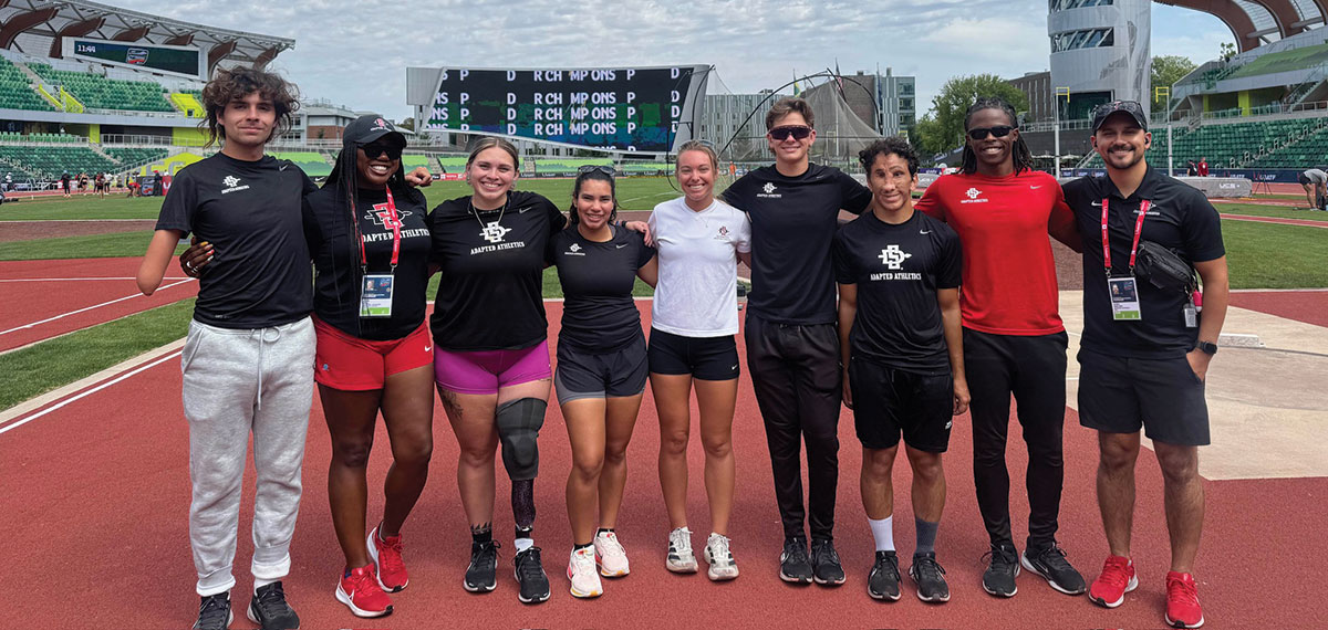 Team members of Adapted Athletics at the 2025 USATF Outdoor & Para National Championships: (from left) Parker Harvey, coach Jasmine Burrell, Alicia Guerrero, Ana Firvida, Michelle Cross (’22, ’25), Austin Spalla, Hammoudi Jauda, coach Rolland Slade and director A.J. Munoz-Bond