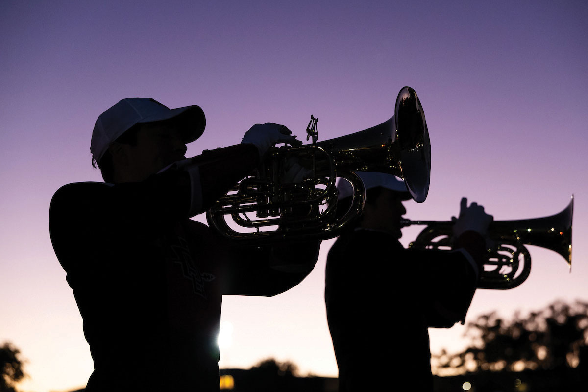 SDSU Pep Band horn players in silhouette