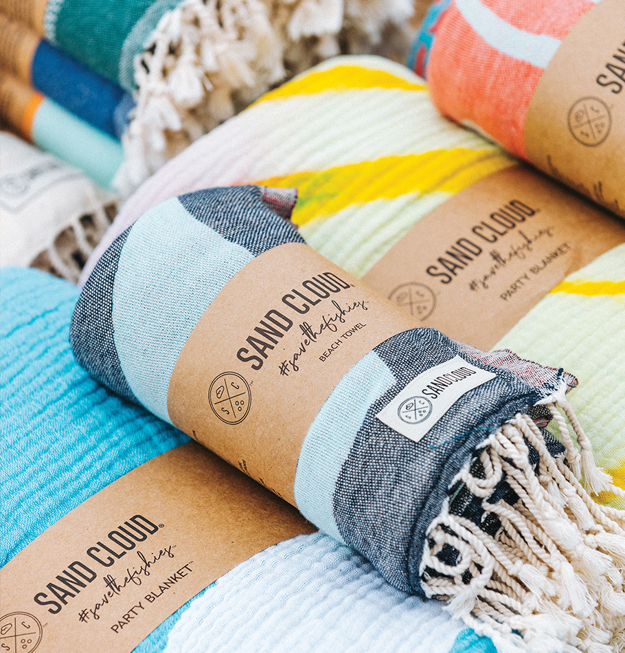 Sand Cloud towels, rolled up with logo printed label