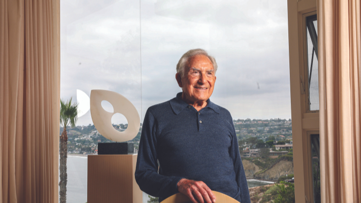 Herbert J. Solomon standing in front of a window