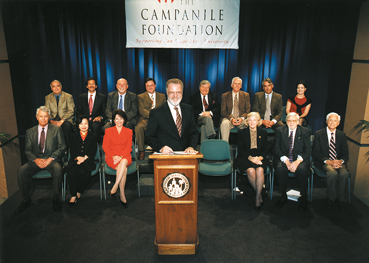 group of people behind a podium