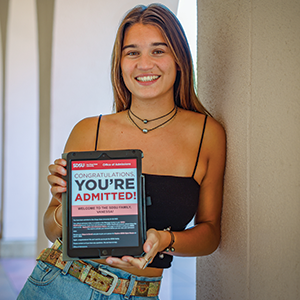 Vanessa Lytle with a tablet showing the "You're admitted" screen