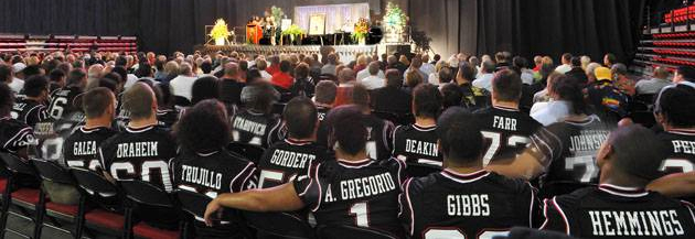 Current SDSU football players look on as the Coryell family speaks.