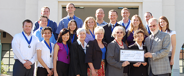 Scholarship recipients, SDSU representatives and members of ARCS present President Weber with a check.