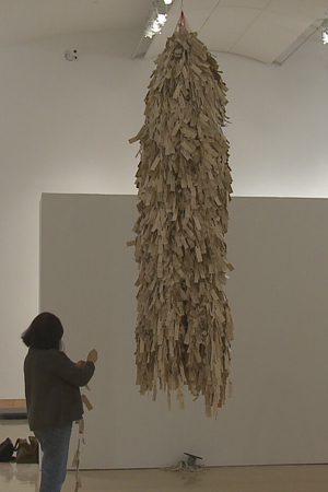 Wendy Maruyama installs The Tag Project at the Escondido Center for the Arts, which hosted the exhibit last year.