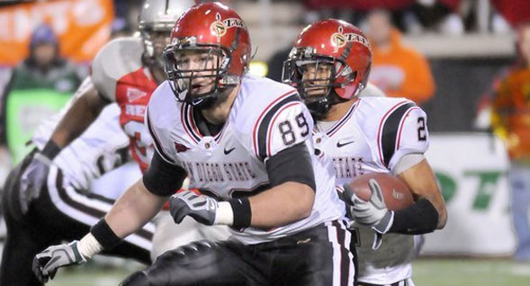 Aztecs tight end Hunter Hewitt clears a path for running back Davion Mauldin.