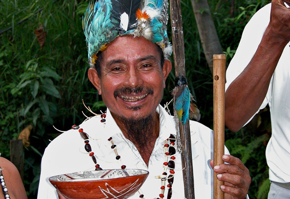 An Ecuadorian man poses with a mucawa  a special bowl used to drink chicha, an Ecuadorian delicacy.