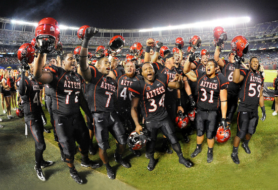 Aztec football players singing the fight song after a victory