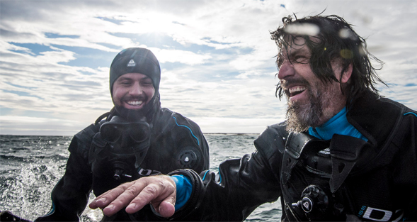 Upon reaching safety on board the zodiac, Steven Quistad, left, and Forest Rohwer breathe a sigh of relief after a close call while diving in Franz Josef Land, Russia. Photo by Andrew Mann/NatGeo