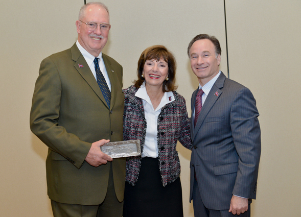 Presidents Service Award honorees Ben and Nikki Clay receive a pewter plate gift from SDSU President Elliot Hirshman. (Photo credit: Frank Villalpando, diFranco Photo)