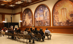Guillermo Aranda examines the mural he painted