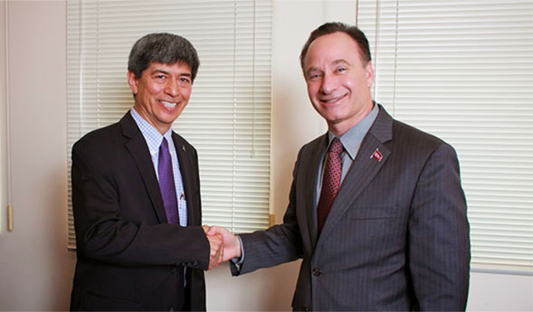 SDSU President Elliot Hirshman shakes hands with CETYS President Fernando Leon Garcia.