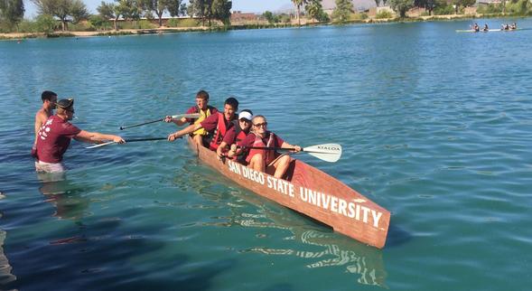In the concrete canoe, front to back, are Debbie Hug, Julia Bermudez, Ross Wong and Bernie Aparicio. Ben Toth and Mike Ellis help bring them ashore.