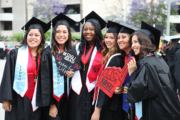 Women celebrating at a 2014 SDSU Commencement ceremony.