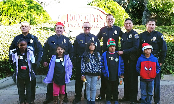 Members of the SDSU Police Department helped children select gifts at Target. (Photo: Michelle Peterson)