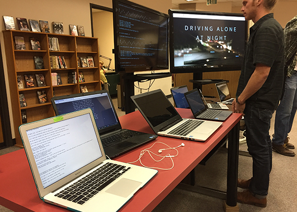 An SDSU tudent views work at last year's Digital Humanities Spring Showcase. (Credit: Pamella Lach)