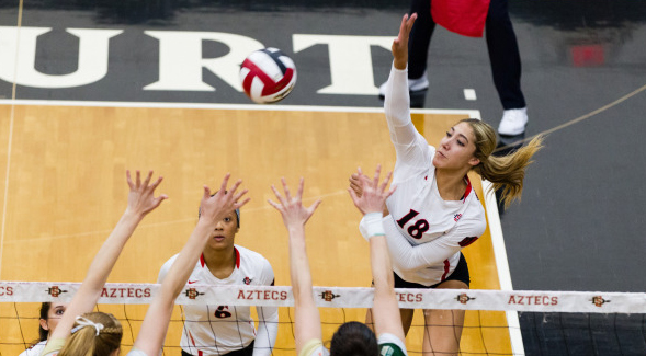 SDSU outside hitter Alexis Cage (#18) attempts a spike during a match earlier this season. (Photo: Derrick Tuskan/GoAztecs)