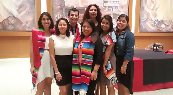 Undocumented Resource Area coordinator Cynthia A. Torres (back) with students