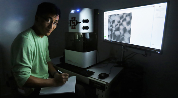 Young Jong Lee, a researcher with the National Institutes of Standards and Technology, uses SDSU's new chemical imaging microscope.